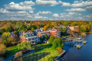 Aerial view of a waterfront area featuring a mix of residential buildings and docks.