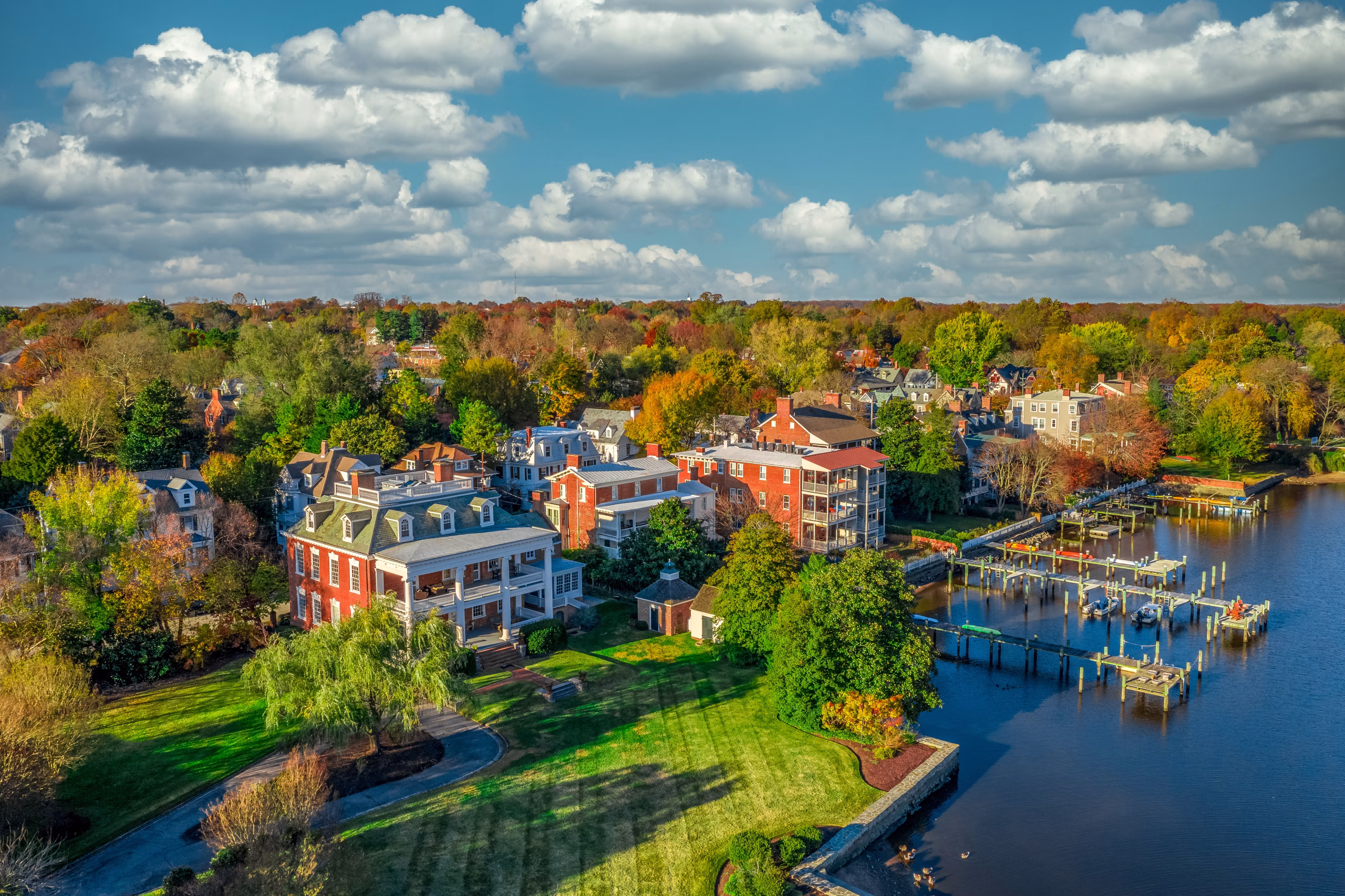 Aerial view of a waterfront area featuring a mix of residential buildings and docks.